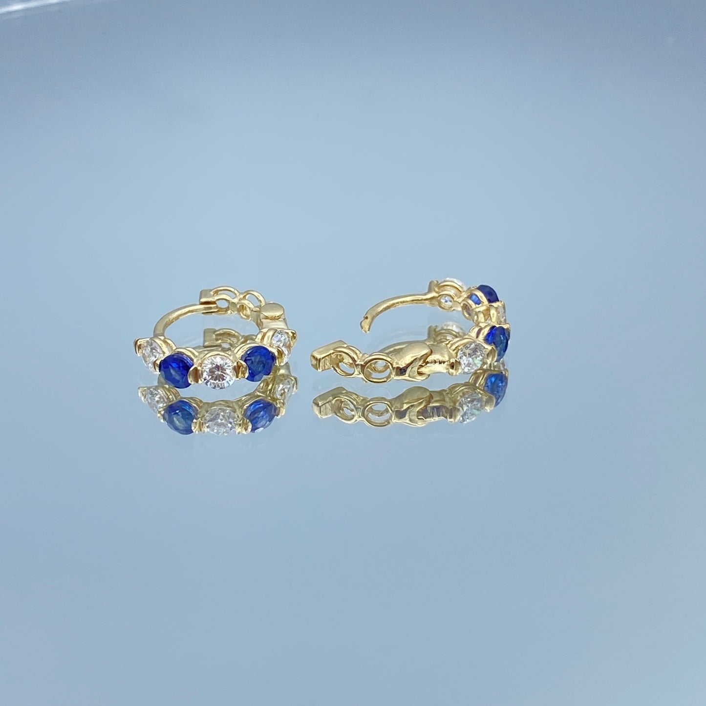 Blue Sapphire and Diamond Huggie Earrings in 14K Yellow Gold